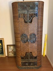2 tall wicker cabinets with decorative elephants.