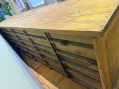 Antique apothecary with many drawers and brass handles.