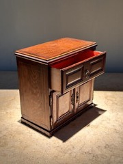 AN UNUSUAL MINIATURE CARVED WOOD APPRENTICE CABINET
