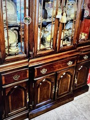 Elegant wooden china cabinet with glass doors and ample storage. 61” wide Brass