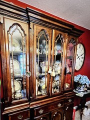 Elegant wooden china cabinet with glass doors and ample storage. 61” wide Brass