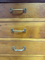 Antique apothecary with many drawers and brass handles.