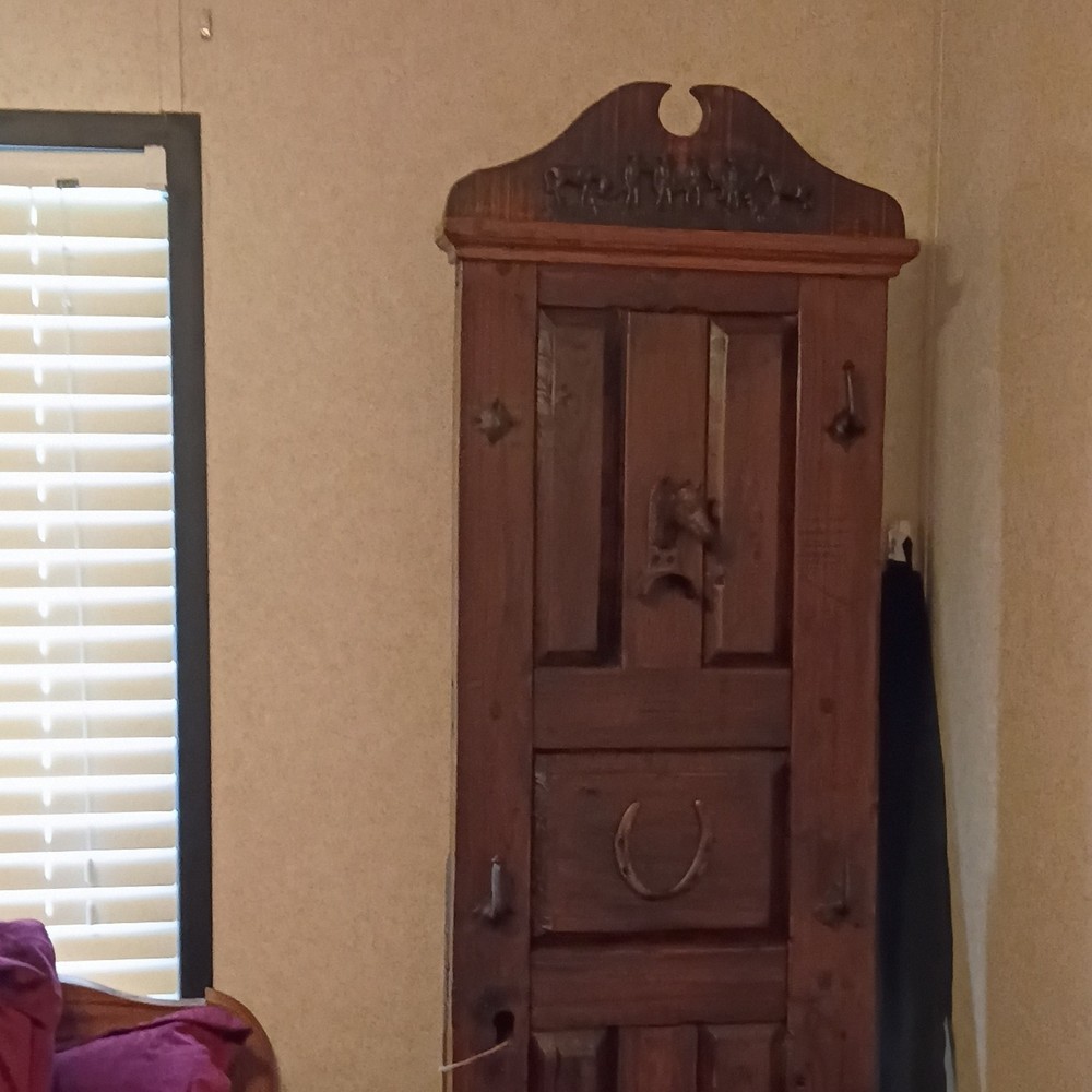 Antique Wooden Cabinet with Raised Panel Door and Decorative Horseshoe Top