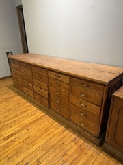 Antique apothecary with many drawers and brass handles.