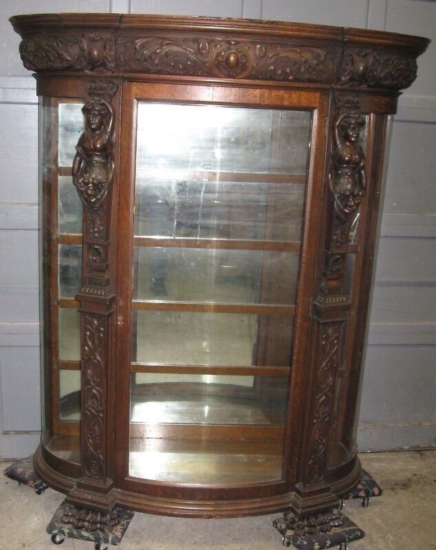 A. J. JOHNSON CARVED OAK CHINA CABINET