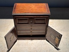 AN UNUSUAL MINIATURE CARVED WOOD APPRENTICE CABINET