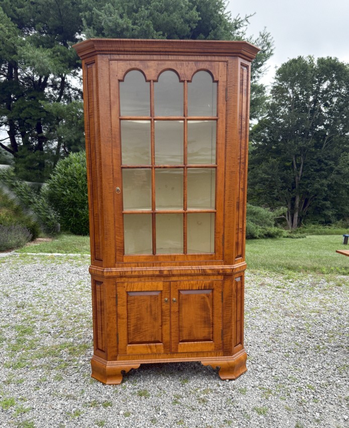 DR Dimes corner cupboard in strong tiger maple for Colonial Williamsburg.
