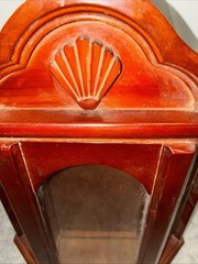 Vintage wall mounted dark wooden curio cabinet with shell shaped pediment