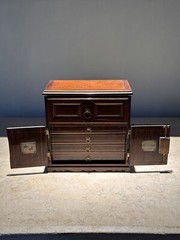 AN UNUSUAL MINIATURE CARVED WOOD APPRENTICE CABINET
