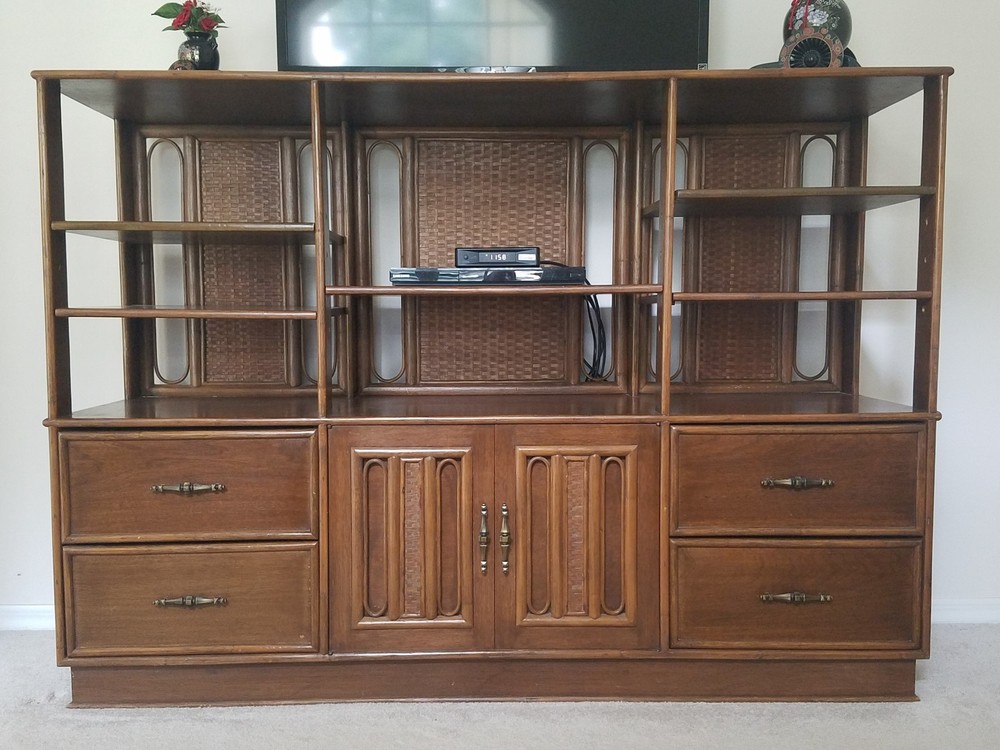 mahogany display cabinet with rattan accents.