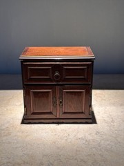 AN UNUSUAL MINIATURE CARVED WOOD APPRENTICE CABINET