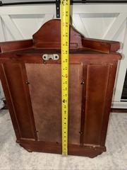 Vintage wall mounted dark wooden curio cabinet with shell shaped pediment