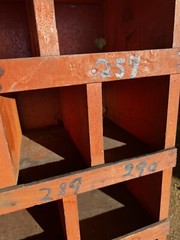 vintage hardware store cubby hole cabinet Old orange paint 109” X 54.5 X 10 3/8