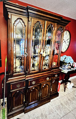 Elegant wooden china cabinet with glass doors and ample storage. 61” wide Brass