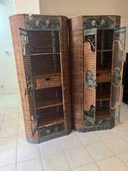 2 tall wicker cabinets with decorative elephants.