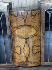 This Is an Asian walnut china cabinet, likely dating from the 1920s to 1930s. I
