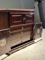 AN UNUSUAL MINIATURE CARVED WOOD APPRENTICE CABINET
