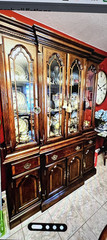 Elegant wooden china cabinet with glass doors and ample storage. 61” wide Brass