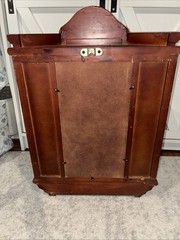 Vintage wall mounted dark wooden curio cabinet with shell shaped pediment