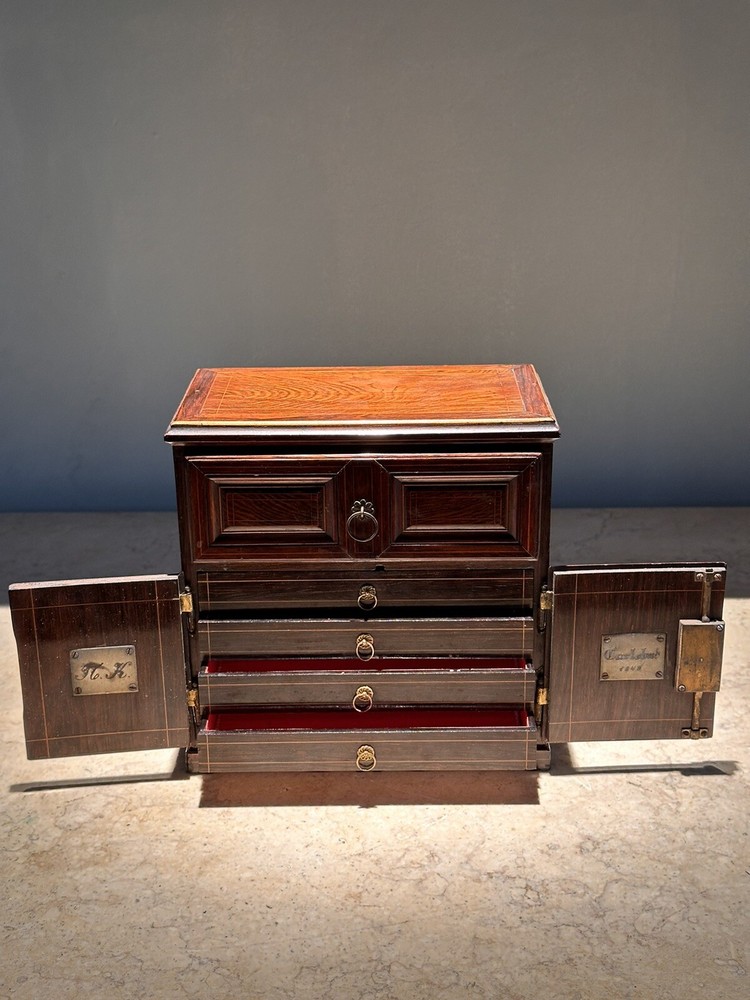 AN UNUSUAL MINIATURE CARVED WOOD APPRENTICE CABINET