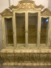 Antique French-style china cabinet with a distressed cream and gold finish.