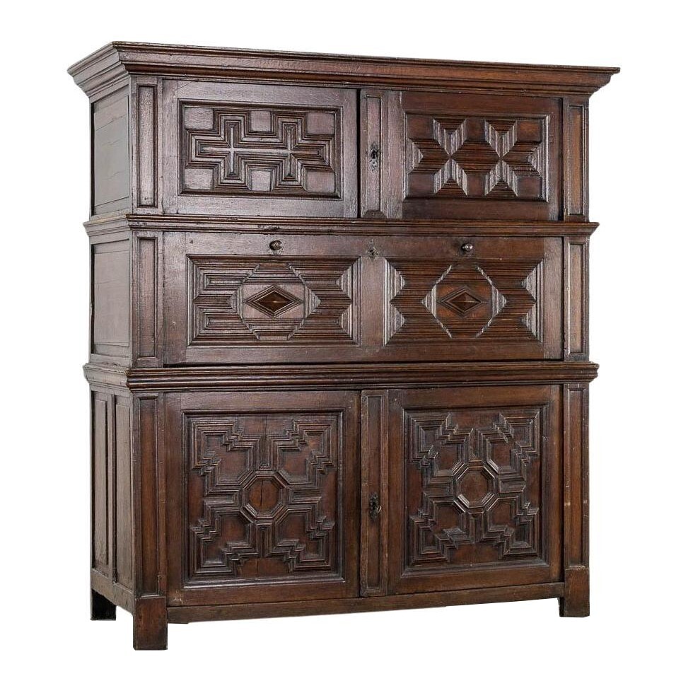 An impressive early 18th century Dutch oak geometric kussen cabinet secretaire